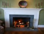 A Soapstone fireplace hearth and surround