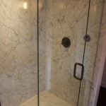 This stall shower is done entirely of white carrara marble